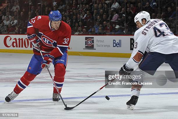 Travis Moen of Montreal Canadiens battles for the puck with Jason Strudwick of Edmonton Oilers during the NHL game on March 11, 2009 at the Bell...
