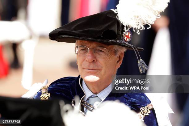 Former British Prime Minister John Major in his role as a Knight Companion walks in the procession to arrive for the Order of The Garter Service at...