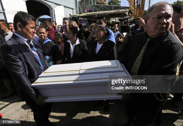 People attend the funeral of a family who died when their house was burnt down, at the "Milagro de Dios" Cemetery in Managua, on June 17, 2018. Six...