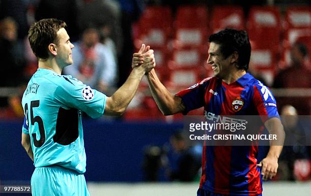 Moscow's Russian goalkeeper and captain Igor Akinfeev celebrates with Chilean midfielder Mark Gonzalez after winning a UEFA Champions League football...