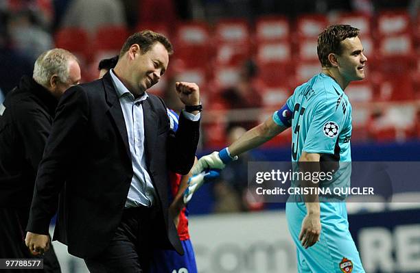 Moscow's coach Leonid Slutsky and Russian goalkeeper and captain Igor Akinfeev celebrates after winning against Sevilla during their UEFA Champions...