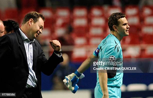 Moscow's coach Leonid Slutsky and Russian goalkeeper and captain Igor Akinfeev celebrates after winning against Sevilla during their UEFA Champions...