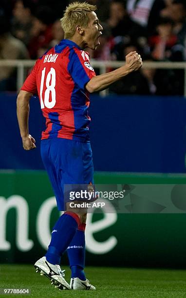 Moscow's Japanesse midfielder Keisuke Honda celebrates after scoring against Sevilla during their UEFA Champions League football match on March 16,...