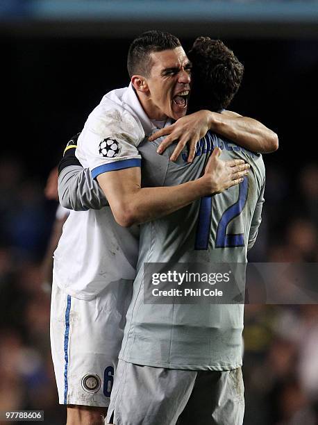 Lucio of Inter Milan celebrates victory with goalkeeper Julio Cesar during the UEFA Champions League Round of 16 second leg match between Chelsea and...