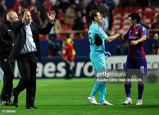 Moscow's coach Leonid Slutsky, Russian goalkeeper and captain Igor Akinfeev and Chilean midfielder Mark Gonzalez celebrate after winning a UEFA...