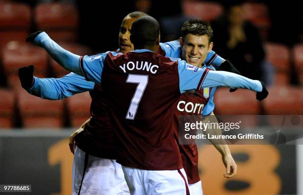 James Milner of Aston Villa celebrates with team mates Gabriel Agbonlahor and Ashley Young after scoring his team's second goal during the Barclays...