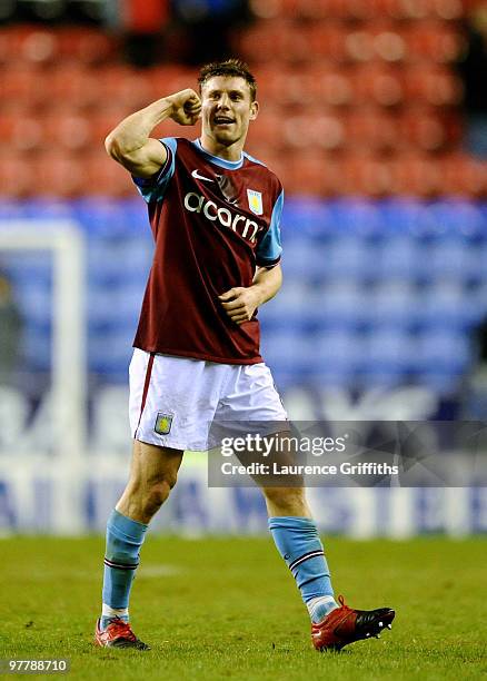 James Milner of Aston Villa celebrates victory after the Barclays Premier League match between Wigan Athletic and Aston Villa at The DW Stadium on...