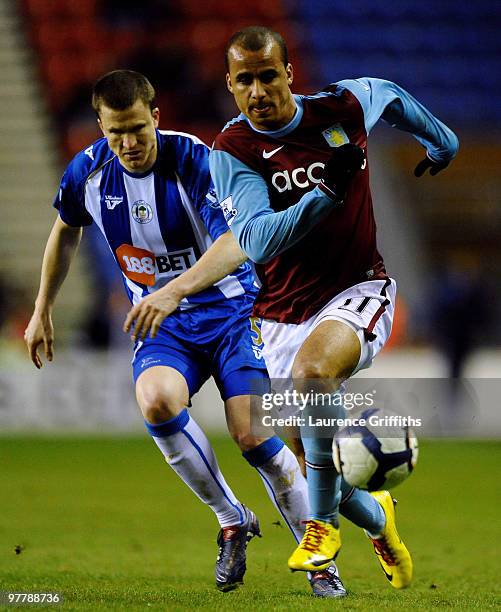 Gabriel Agbonlahor of Aston Villa battles with Gary Caldwell of Wigan during the Barclays Premier League match between Wigan Athletic and Aston Villa...