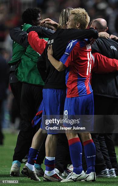 Keisuke Honda of CSKA Moscow celebrates with his teammates at the end of the UEFA Champions League round of sixteen second leg match between Sevilla...