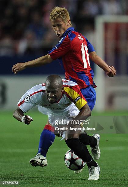 Keisuke Honda of CSKA Moscow fights for the ball with Didier Zokora of Sevilla during the UEFA Champions League round of sixteen second leg match...