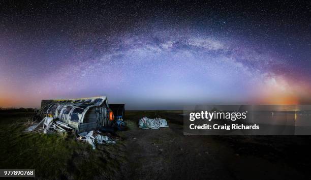 galaxy over cottage on holy island, uk - northumberland stock pictures, royalty-free photos & images