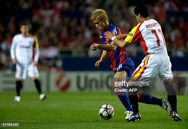 Sevilla's Brazilian midfielder Renato vies with CSKA Moscow's Japanesse midfielder Keisuke Honda during their UEFA Champions League football match on...