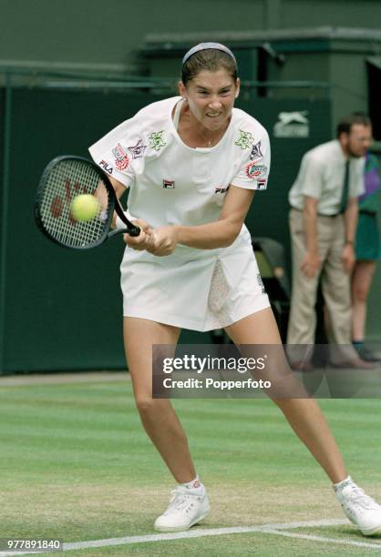 Monica Seles of the United States returns the ball against Gigi Fernandez of the United States during the Ladies Singles fourth round on day six of...