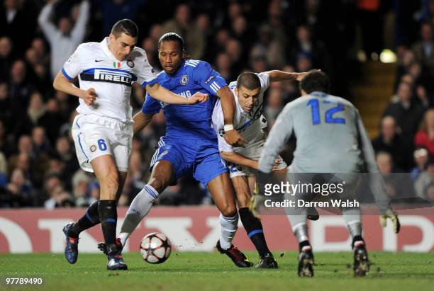 Didier Drogba of Chelsea is shut down by Lucio and Walter Samuel of Inter Milan during the UEFA Champions League Round of 16 second leg match between...