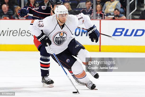 Foward Andrew Cogliano of the Edmonton Oilers skates with the puck against the Columbus Blue Jackets on March 15, 2010 at Nationwide Arena in...