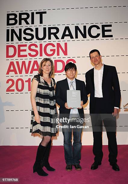 Min-Kyu Choi accepts the Brit Insurance Design of the Year Award from jury chair Antony Gormley and Awards Presenter Sarah Montague at the Design...