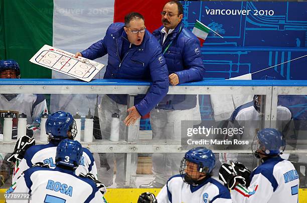 Werner Winkler, Gianluigi Rosa and Andrea Chiarotti of Italy listen to their head coach Massimo da Rin during the Ice Sledge Hockey Preliminary Round...