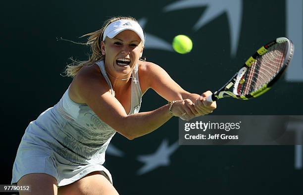 Caroline Wozniacki of Denmark returns a backhand against Nadia Petrova of Russia during the BNP Paribas Open at the Indian Wells Tennis Garden on...