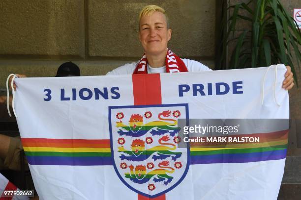 England fan and LGBT rights campaigner Di Cunningham displays a flag before the Russia 2018 World Cup Group G football match between Tunisia and...