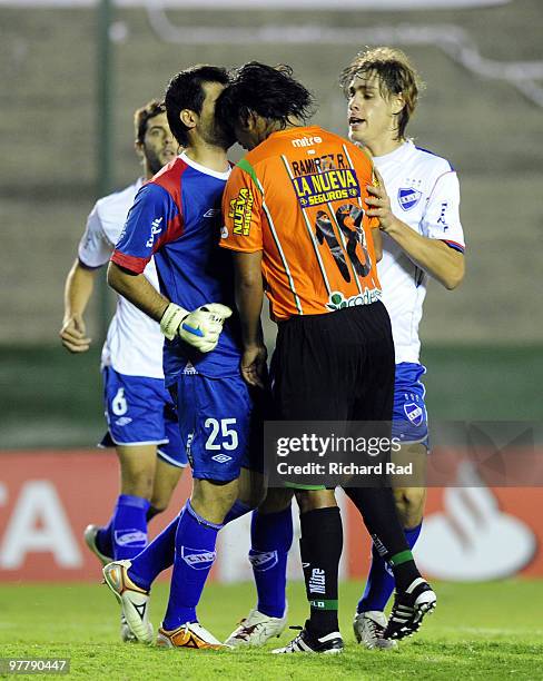 Ruben Ramirez of Argentina's Banfield clashes with Sebastian Fernandez, goalkeeper of Uruguay's Nacional, during their 2010 Libertadores soccer match...