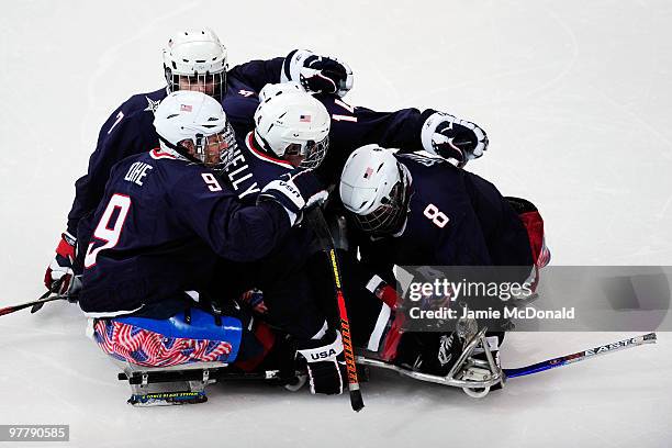 Greg Shaw of the United States celebrates his goal with teammates Andy Yohe, Taylor Lipsett, Jimmy Connelly and Josh Pauls during the first period of...