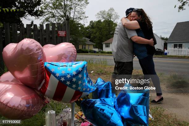 Eric and Maureen Glockenberg leave balloons at a makeshift memorial outside the home of Stewart R. Weldon on Page Boulevard in Springfield, MA on...