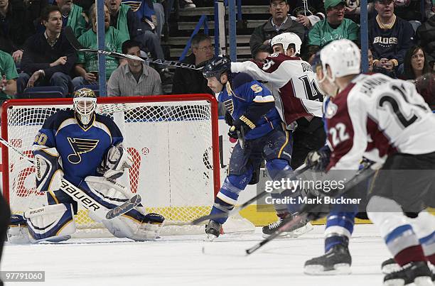 Chris Mason of the St. Louis Blues watches the inbound puck shot by Scott Hannan of the Colorado Avalanche on March 16, 2010 at Scottrade Center in...