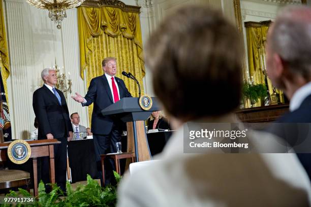 President Donald Trump, center, speaks as U.S. Vice President Mike Pence, left, listens during a National Space Council meeting in the East Room of...
