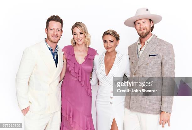Brian Kelley and Tyler Hubbard of Florida Georgia Line pose with Brittney Hayley Hubbard and Marie Kelley at the 2018 CMT Music Awards Show: Portrait...