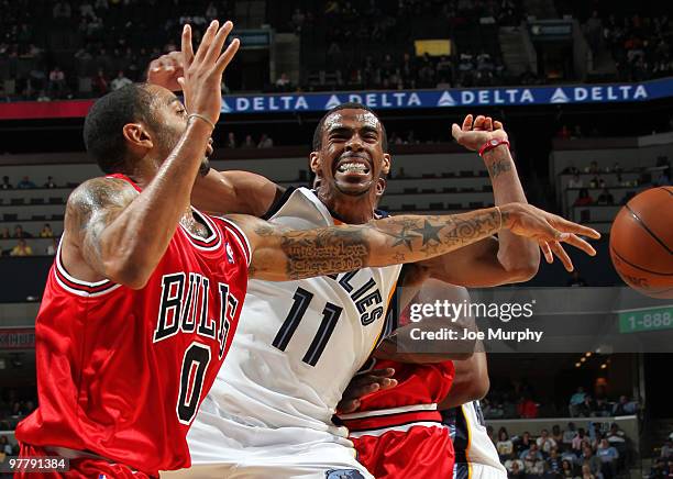 Mike Conley of the Memphis Grizzlies fights against a pick as Acie Law of the Chicago Bulls passes the ball during a game on March 16, 2010 at...