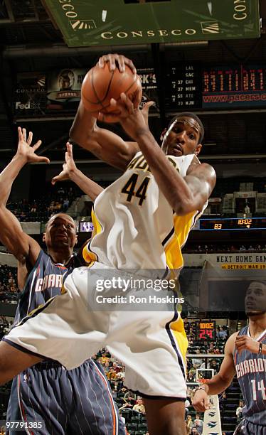 Solomon Jones of the Indiana Paces rebounds over Theo Ratliff of the Charlotte Bobcats at Conseco Fieldhouse on March 16, 2010 in Indianapolis,...