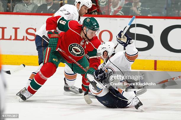 Mikko Koivu of the Minnesota Wild battles for the puck with Sam Gagner of the Edmonton Oilers during the game at the Xcel Energy Center on March 16,...