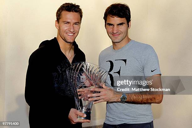 Marco Chiudinelli of Switzerland is presented the Comeback Player of the Year award by Roger Federer of Switzerland during the BNP Paribas Open on...