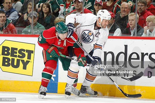 Andrew Brunette of the Minnesota Wild and Ethan Moreau of the Edmonton Oilers battle for position during the game at the Xcel Energy Center on March...