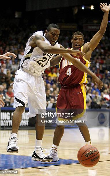 Savalace Townsend of the Arkansas Pine-Bluff Golden Lions loses control of the ball next to Reggie Middleton of the Winthrop Eagles during the...