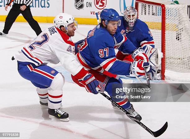 Matt Gilroy of the New York Rangers skates against Dominic Moore of the Montreal Canadiens on March 16, 2010 at Madison Square Garden in New York...