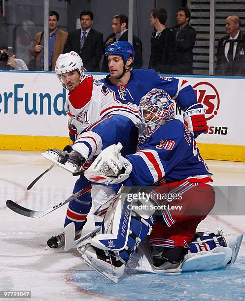 Henrik Lundqvist and Dan Girardi of the New York Rangers protect the net against Brian Gionta of the Montreal Canadiens on March 16, 2010 at Madison...