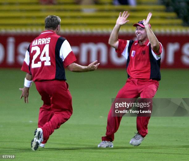 South Australians Ryan Harris and David Fitzgerald celebrate after Fitzgerald caught New South Wales batsman Graeme Rummans off Harris's bow;ling for...
