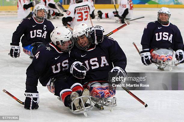 Nikko Landeros of the United States celebrates his goal with teammate Jimmy Connelly during the Ice Sledge Hockey Preliminary Round Group A Game...