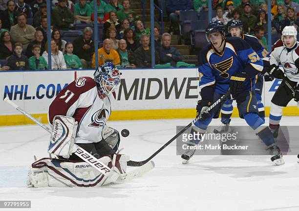 Peter Budaj of the Colorado Avalanche stops the puck in front of David Perron of the St. Louis Blues on March 16, 2010 at Scottrade Center in St....