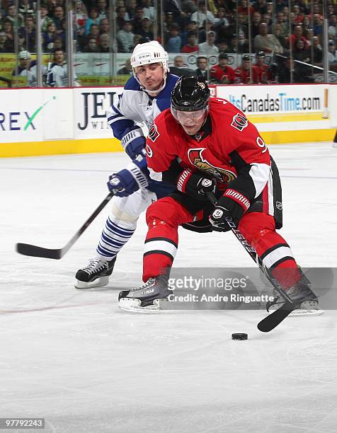 Milan Michalek of the Ottawa Senators stickhandles the puck around Tomas Kaberle of the Toronto Maple Leafs at Scotiabank Place on March 16, 2010 in...