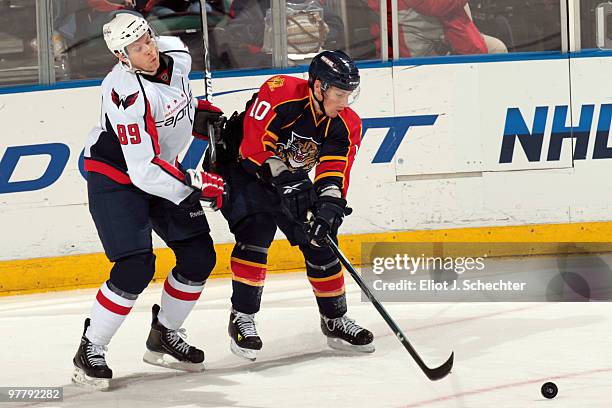 David Booth of the Florida Panthers tangles with Tyler Sloan of the Washington Capitals at the BankAtlantic Center on March 16, 2010 in Sunrise,...