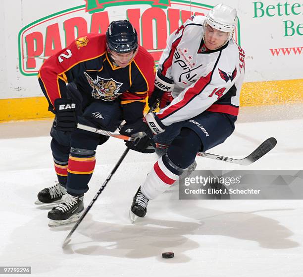 Keith Ballard of the Florida Panthers crosses sticks with Tomas Fleischmann of the Washington Capitals at the BankAtlantic Center on March 16, 2010...