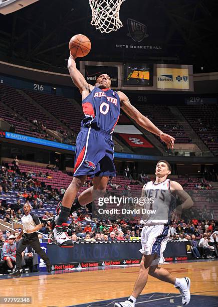 Jeff Teague of the Atlanata Hawks dunks the basketball against the New Jersey Nets on March 16, 2010 at the Izod Center in East Rutherford, New...