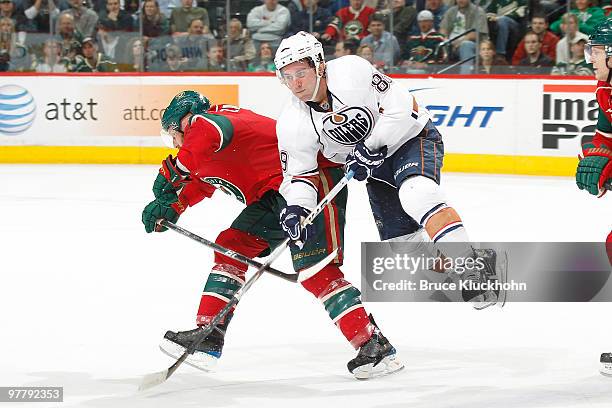 Sam Gagner of the Edmonton Oilers collides with Greg Zanon of the Minnesota Wild during the game at the Xcel Energy Center on March 16, 2010 in Saint...