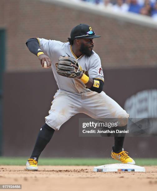 Josh Harrison of the Pittsburgh Pirates throws to first base against the Chicago Cubs at Wrigley Field on June 8, 2018 in Chicago, Illinois. The Cubs...