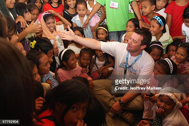 Patrick Halton of England, UNICEF Philippines Child Protection specialist, is seen with children affected by the fighting between Philippine security...