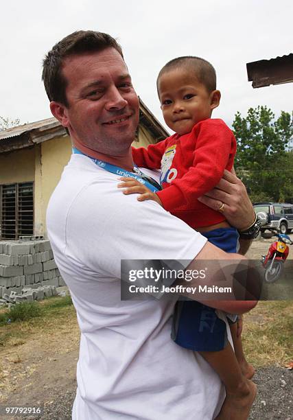 Patrick Halton of England, UNICEF Philippines Child Protection specialist, is seen carrying a Filipino Muslim kid affected by the fighting between...