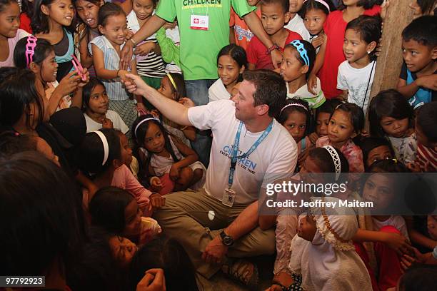 Patrick Halton of England, UNICEF Philippines Child Protection specialist, is seen with children affected by the fighting between Philippine security...