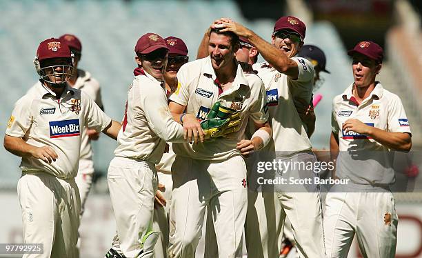 Luke Feldman of the Bulls celebrates with his team mates after dismissing Andrew McDonald of the Bushrangers during day one of the Sheffield Shield...